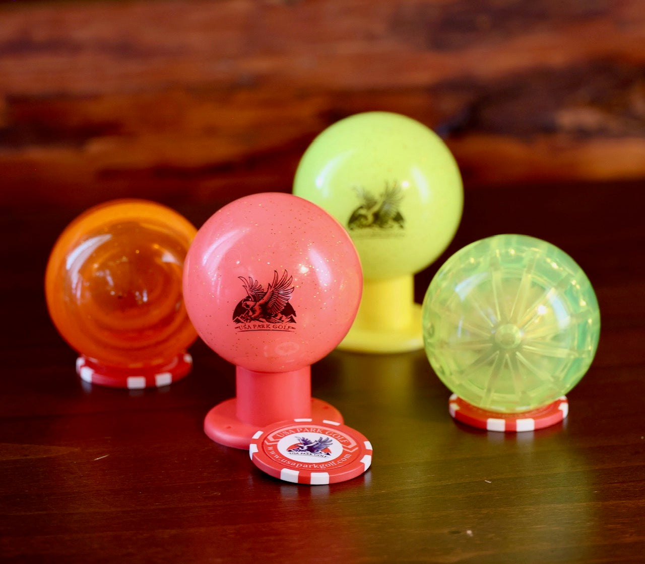 bright colored balls with a usa park golf shaft in front