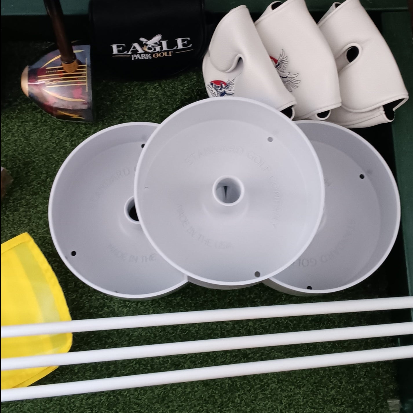 Plastic Park Golf Cups with Flagsticks and Park Golf Head Covers.