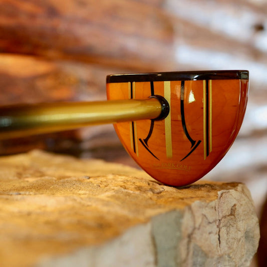 Wooden head prak golf club on a stone shelf