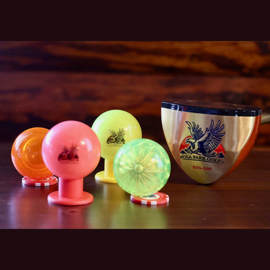 Bright colored park golf balls and a USA Park Golf Club head.